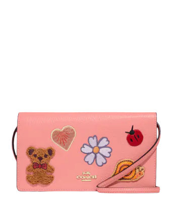 coach-anna-foldover-clutch-crossbody-with-creature-patches.png